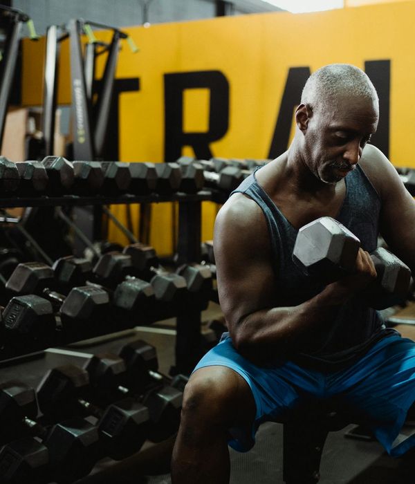 Man performing focused strength exercise in modern gym environment
